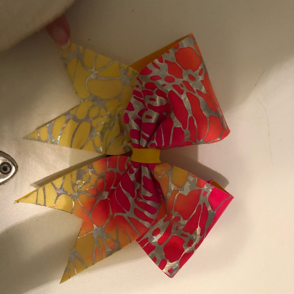 Coral, pink, yellow, and orange cheer bow
